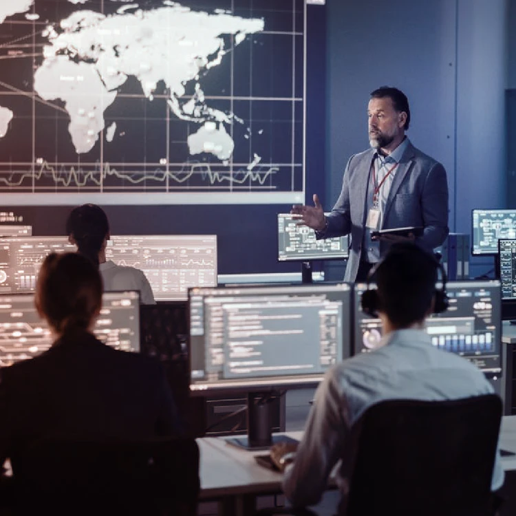 A manager presents market data and charts on a large screen during a business meeting focused on innovation.