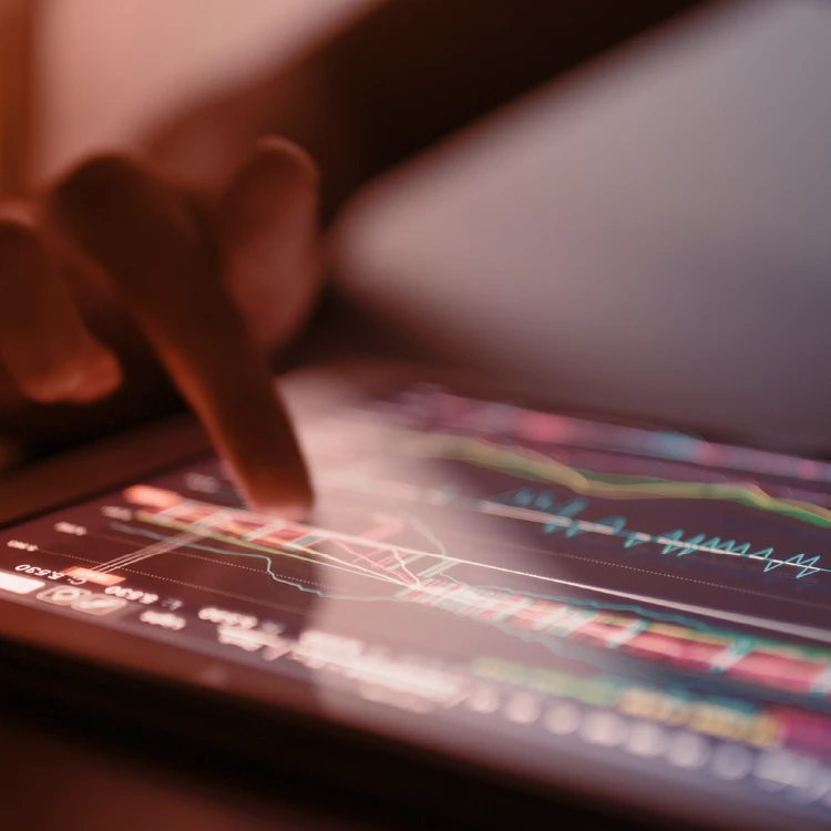 Foreground tablet screen showing in-depth analysis of performance charts and data processing to optimize business processes.